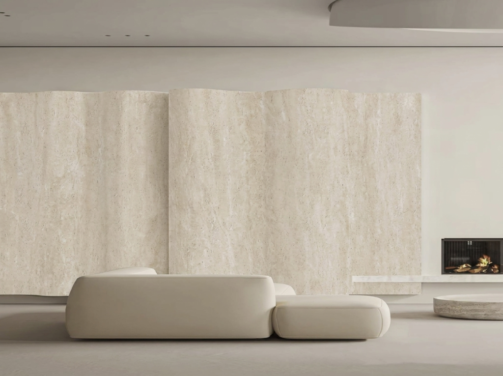 Living room with a curved travertine-finish feature wall, white sofa and fireplace