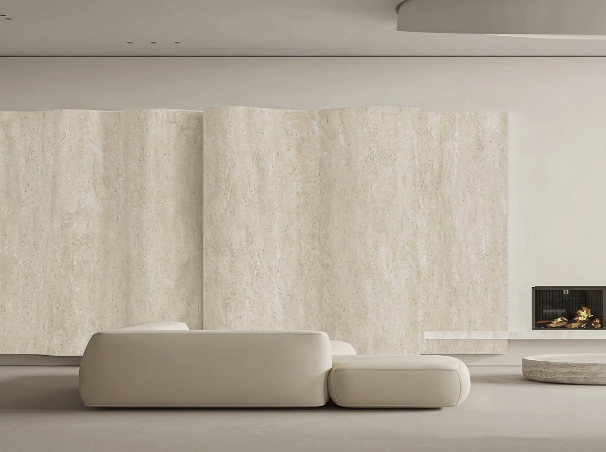 Living room with a curved travertine-finish feature wall, white sofa and fireplace